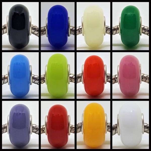 May include: Twelve round glass beads in various colours, including black, blue, white, green, light blue, lime green, red, pink, purple, orange, yellow, and white. The beads are strung on a silver chain.