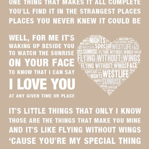 May include: A beige poster with white text. The text includes song lyrics and phrases like "Flying Without Wings" and "I Love You." A heart-shaped design is filled with words related to the song and artist.