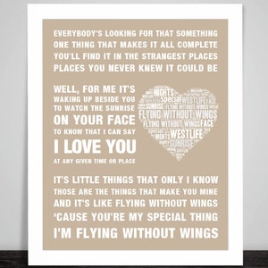 May include: A framed print with a beige background features white text. The text includes song lyrics and the words "I Love You" in a bold font. A heart-shaped design contains the words "Westlife" and "Flying Without Wings".