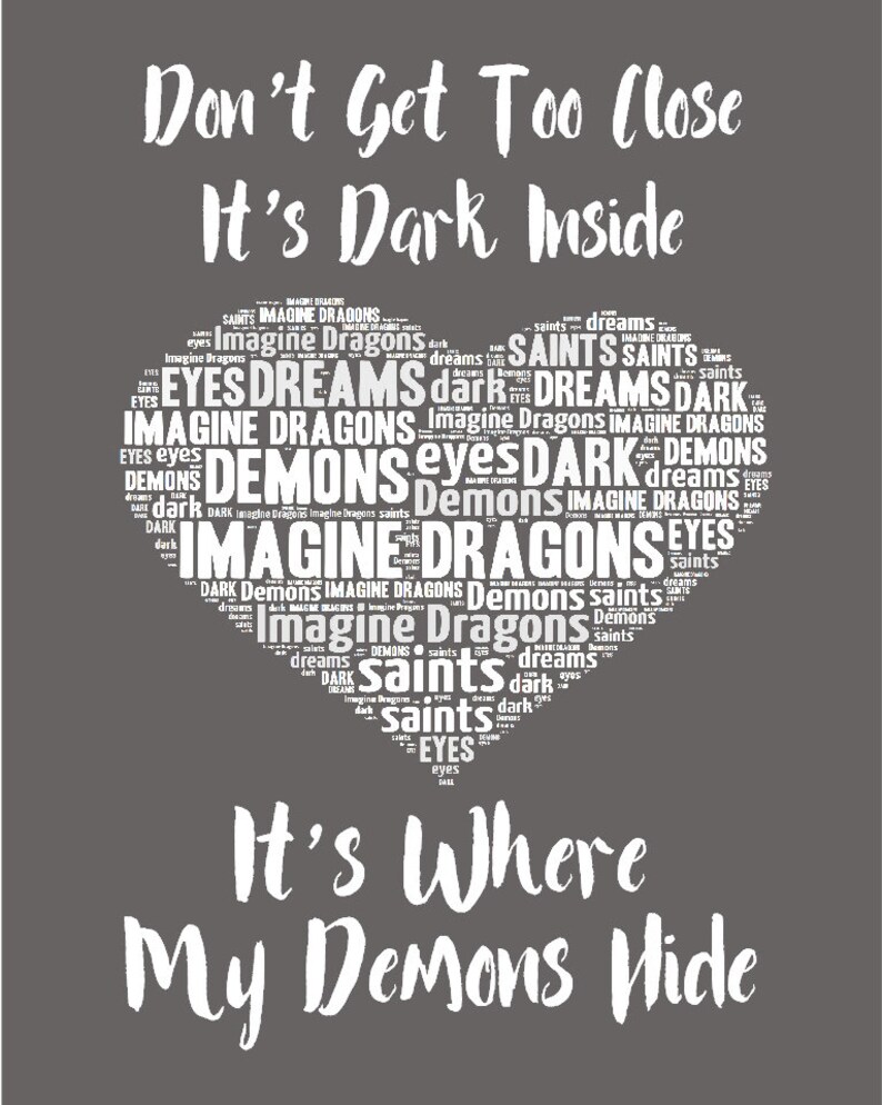 May include: A dark gray background with white text that reads "Don't Get Too Close It's Dark Inside" and a heart-shaped word cloud with the words "Imagine Dragons, Demons, Saints, Dreams, Dark, Eyes" in white. The text below the heart reads "It's Where My Demons Hide".