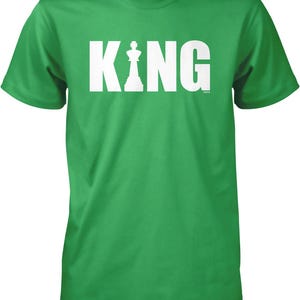 A green t-shirt with the word "KING" printed in white letters.