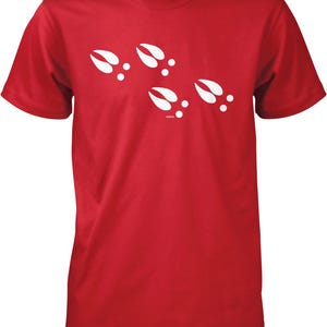 A red t-shirt with white paw prints printed on it.