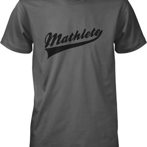 May include: Dark gray t-shirt with the word "Mathlete" in a black, stylized script across the chest. The word is above a black banner. The shirt has short sleeves and a crew neck.