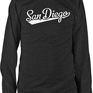 May include: Black long-sleeve shirt with the white text "San Diego" in a script font with a white angled underline. The shirt has a crew neck and ribbed cuffs.