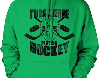 May include: A bright green hooded sweatshirt featuring a black graphic print on the chest. The design includes a goalie mask, two crossed hockey sticks, two pucks, and the text I'D RATHER BE PLAYING HOCKEY in a bold, distressed font.