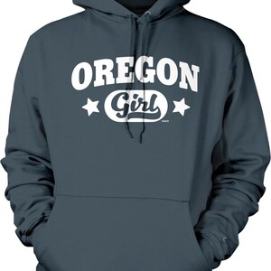 A dark grey hoodie with the text "OREGON GIRL" printed on it in white.