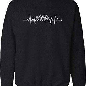 May include: Black crew neck sweatshirt with a white graphic of a heartbeat line. The heartbeat line has the word "HAHAHA" in the center. The sweatshirt is made of a soft material.