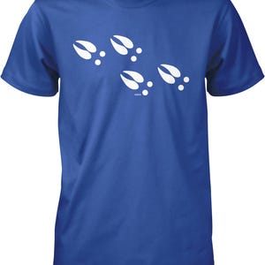 A blue t-shirt with white paw prints printed on it.