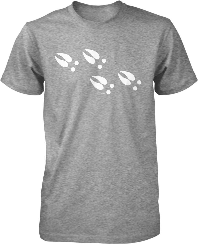 A gray t-shirt with a graphic design of white paw prints.