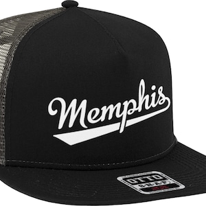 May include: Black trucker hat with a mesh back and a flat brim. The word "Memphis" is written in white script across the front, with a white angled accent below. The hat has a snap closure.