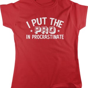 A red t-shirt with the text "I PUT THE PRO IN PROCRASTINATE" printed on it.