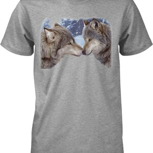May include: A heather gray short-sleeve t-shirt featuring a graphic print of two wolves facing each other with their noses touching. The wolves are depicted in shades of brown, gray, and white, set against a snowy, forested background.