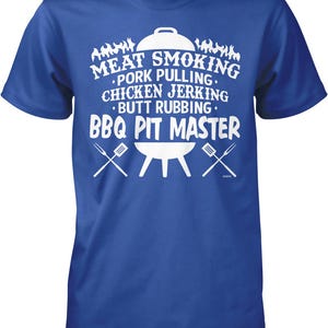 A blue t-shirt with white text that says "MEAT SMOKING PORK PULLING CHICKEN JERKING BUTT RUBBING BBQ PIT MASTER".