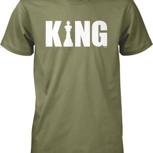 A green t-shirt with the word "KING" printed in white letters.
