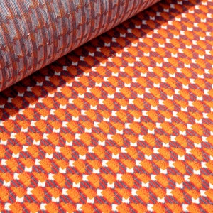 May include: Orange and gray patterned fabric with a geometric design. The fabric is folded in half, showing the pattern on both sides.