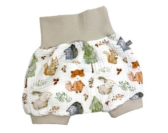 May include: White baby bloomers with a beige waistband and a woodland animal print featuring foxes, squirrels, rabbits, and hedgehogs.