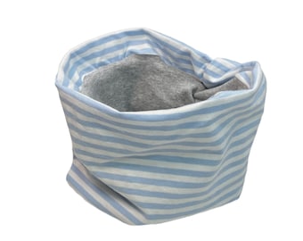 May include: A blue and white striped neck warmer with a gray fleece lining. The neck warmer is made of soft, comfortable fabric and is perfect for keeping warm in the winter.