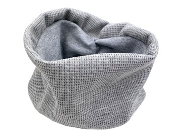 May include: Gray waffle knit fabric neck warmer. The fabric is soft and comfortable.