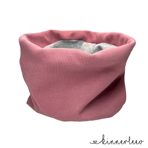 May include: A pink ribbed knit neck warmer with a grey lining.