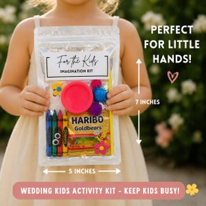 May include: A clear plastic bag labeled "For the Kids" containing crayons, a pink disc, colorful pom-poms, and a packet of Haribo Goldbears. The bag is 5 inches wide and 7 inches tall. Text reads "Perfect for Little Hands!" and "Wedding Kids Activity Kit - Keep Kids Busy!"