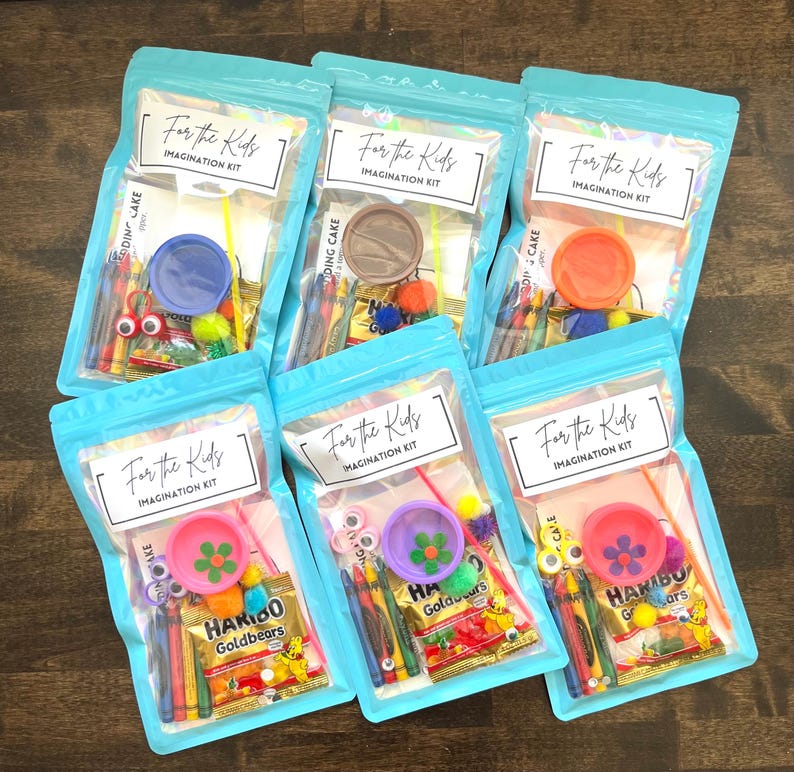 May include: Six clear plastic bags with a light blue zipper, each containing an "Imagination Kit" for kids. The kits include crayons, craft supplies, and a small container. The bags are labeled "For the Kids".