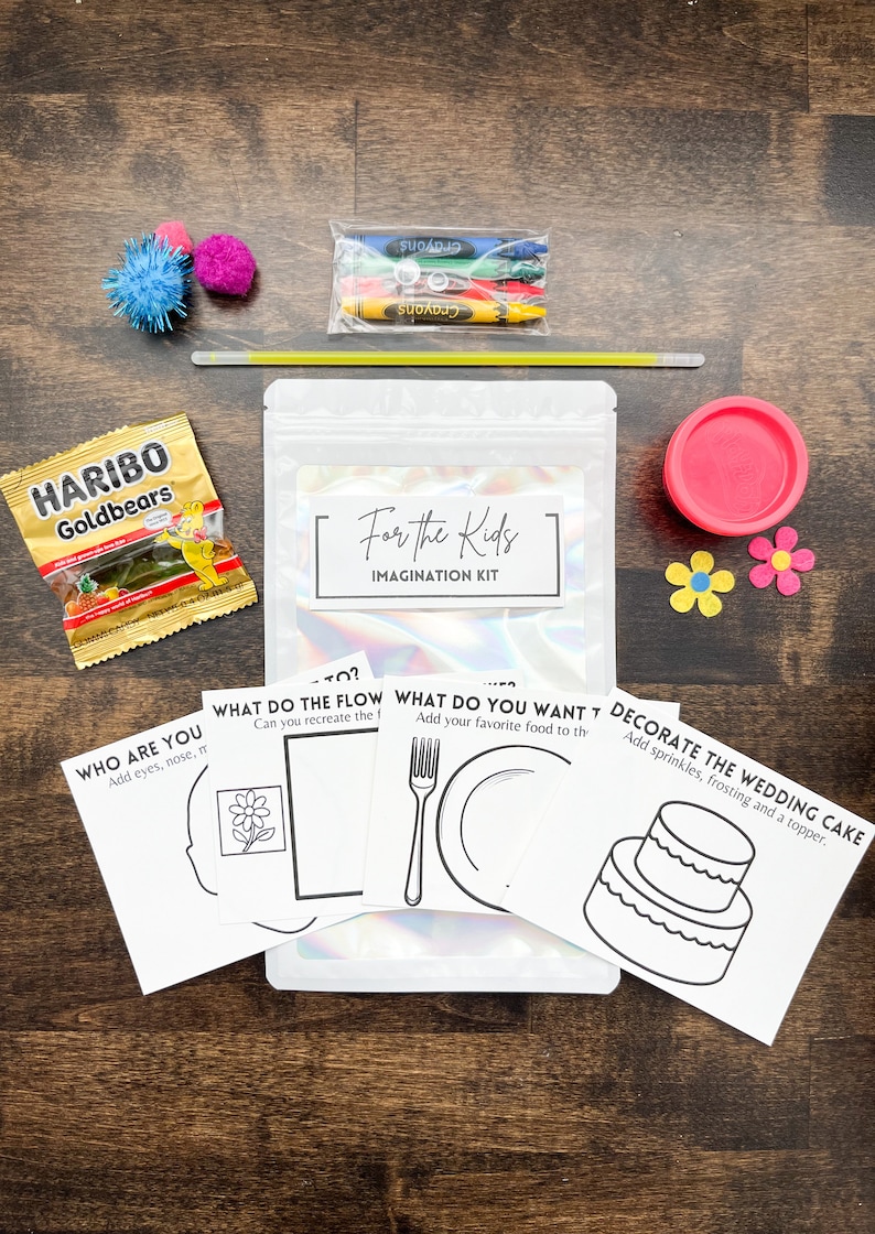 May include: An "Imagination Kit" with crayons, playdough, and activity cards. The kit includes a bag with the text "For the Kids IMAGINATION KIT", a pack of crayons, a container of pink playdough, and several activity cards.