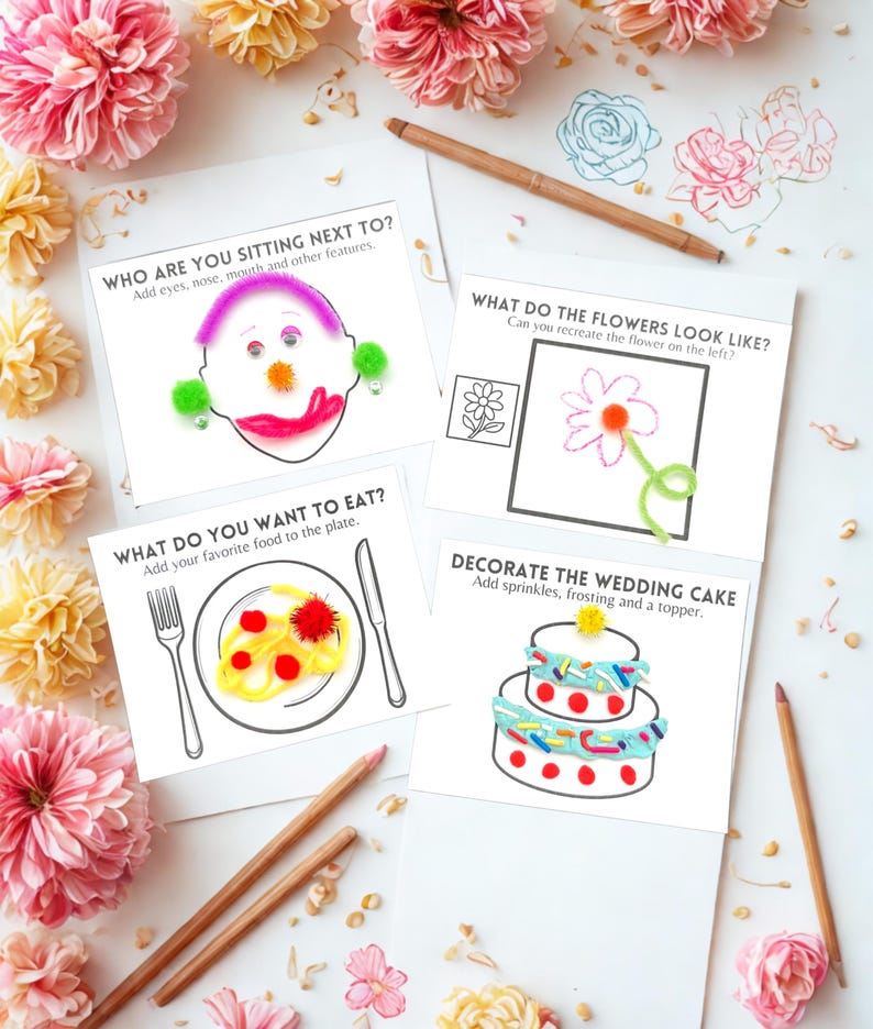 May include: Four white cards with drawing prompts, including "Who are you sitting next to?" and "Decorate the wedding cake." The cards are surrounded by pink and yellow flowers and pencils. The prompts encourage creative drawing and decoration.