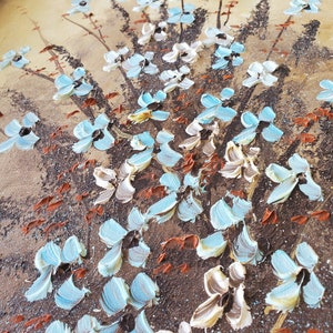 May include: A painting of a floral bouquet with blue and white flowers on a brown background.