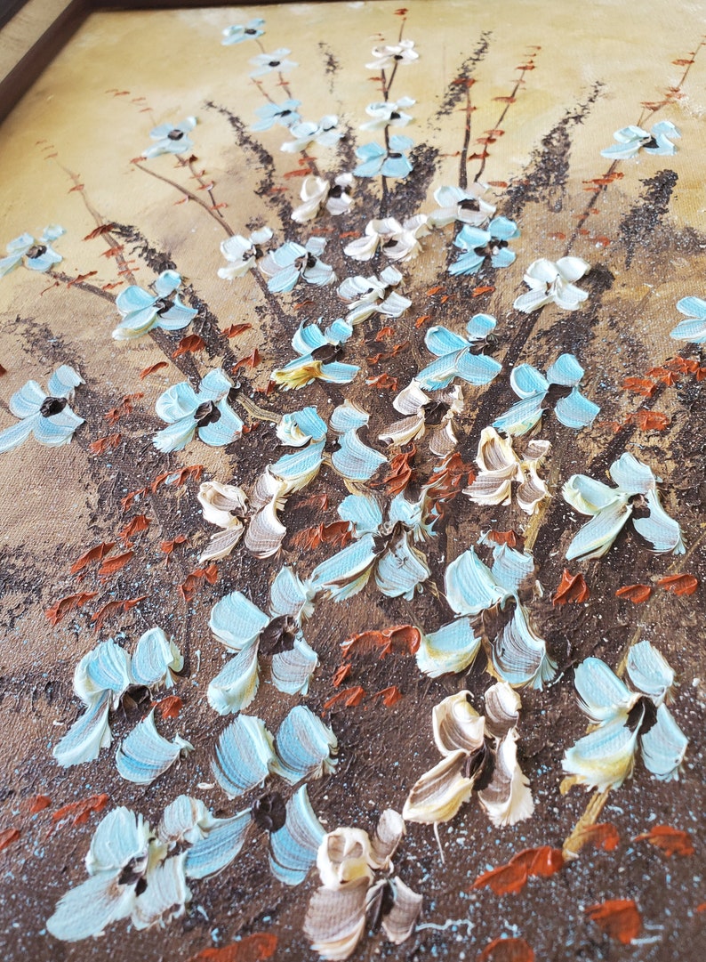 May include: A painting of a floral bouquet with blue and white flowers on a brown background.