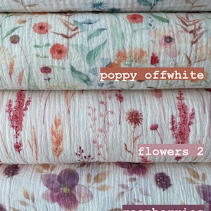 May include: Five different fabric swatches with floral patterns. The top swatch features blue flowers, the second features orange poppy flowers, the third features pink flowers, the fourth features pink raspberries, and the bottom features purple blueberries.