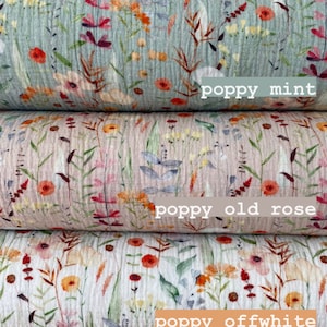 May include: Five different fabric swatches with a floral pattern. The fabrics are stacked on top of each other. The top fabric is white with small flowers. The second fabric is light blue with a larger floral pattern. The third fabric is light pink with a larger floral pattern. The fourth fabric is off-white with a larger floral pattern. The bottom fabric is light brown with a larger floral pattern. The text "small flowers", "poppy mint", "poppy old rose", "poppy offwhite", and "poppy taupe" is printed below each fabric swatch.
