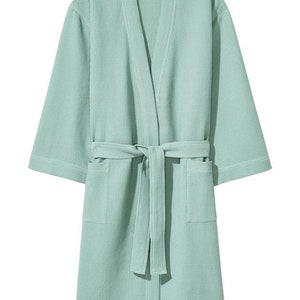 May include: A light green waffle weave bathrobe with a self-tie belt and two pockets.