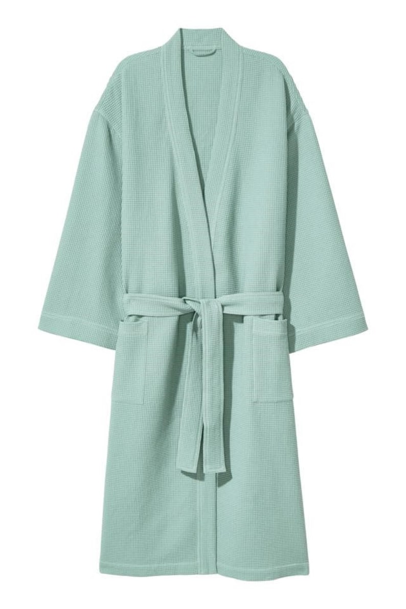 May include: A light green waffle weave bathrobe with a self-tie belt and two pockets.