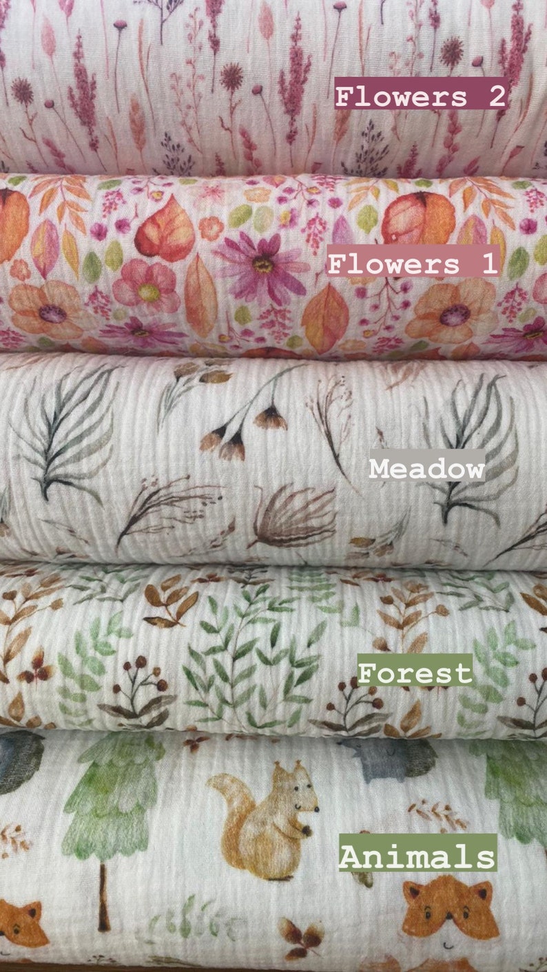 May include: Five different fabric swatches with various nature-inspired prints. The swatches are stacked on top of each other. The top swatch features a pink and white floral pattern with the text "Flowers 2". The second swatch features a pink and orange floral pattern with the text "Flowers 1". The third swatch features a brown and white meadow pattern with the text "Meadow". The fourth swatch features a green and brown forest pattern with the text "Forest". The bottom swatch features a green and brown animal pattern with the text "Animals".