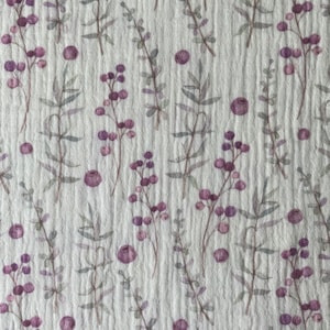 May include: A white fabric with a repeating pattern of small purple flowers and leaves. The fabric has a subtle texture.