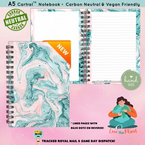 May include: An A5 notebook with a pink and blue marbled cover. The notebook is carbon neutral and vegan friendly. It has lined pages with bujo dots on the reverse. The notebook is hand-made and says "Love the Planet" on the back.