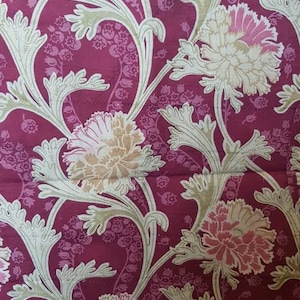 May include: A repeating pattern of pink and white flowers with green leaves on a burgundy background. The floral design is reminiscent of vintage wallpaper.
