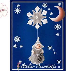 May include: DIY kit for a felt ornament featuring a gray snowflake, a crescent moon, and a small felt figure wearing a gray hooded cloak and holding a pine cone. The figure is hanging from the snowflake. The background is a dark blue.