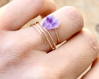 May include: A gold wire ring with a small cluster of amethyst crystals.