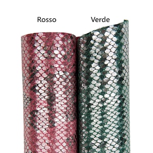 May include: Two rolls of textured fabric, one in a deep red color and the other in a dark green. The fabric has a scale-like pattern with a metallic sheen. The word "Rosso" is above the red fabric and "Verde" is above the green fabric.