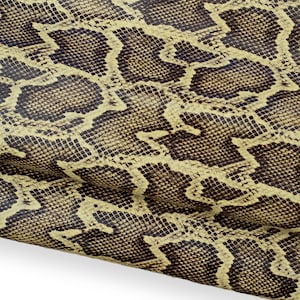 May include: Close-up of a snakeskin pattern. The design features a repeating pattern of dark brown and tan scales, creating a textured appearance. The snakeskin pattern is a popular design for fashion and accessories.