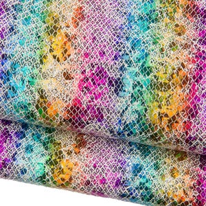 May include: A close-up of a fabric with a rainbow snakeskin pattern. The design features a silver net overlaying a vibrant mix of colors, including pink, purple, blue, green, yellow, and orange. The fabric is folded, showing its texture.