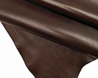 May include: Close-up of a piece of brown leather with a smooth, textured surface.