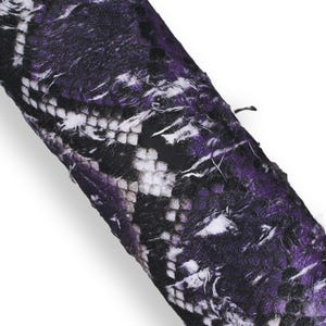 May include: Close-up of a rolled fabric with a snakeskin pattern in shades of purple, black, and white. The word "Viola" is printed at the bottom of the image.