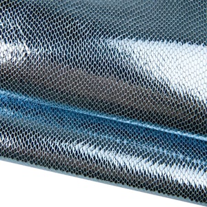 May include: Close-up of a shiny, textured material with a scale-like pattern. The fabric has a metallic sheen, with shades of silver and blue. The surface reflects light, creating a shimmering effect. The material appears to be folded or draped.