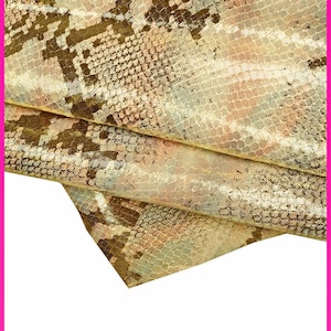 May include: A close-up of a fabric with a snakeskin pattern in shades of brown, gold, and beige. The fabric is folded and the edges are visible.