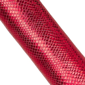 May include: A roll of red faux leather with a snakeskin pattern. The material has a glossy finish and a repeating diamond-shaped texture. The roll is angled diagonally against a white background.