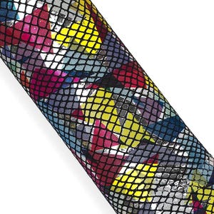 May include: A rolled sheet of material featuring a multi-colored geometric pattern of yellow, magenta, blue, and silver shapes overlaid with a black grid texture that creates a repeating scale-like appearance across the entire surface.