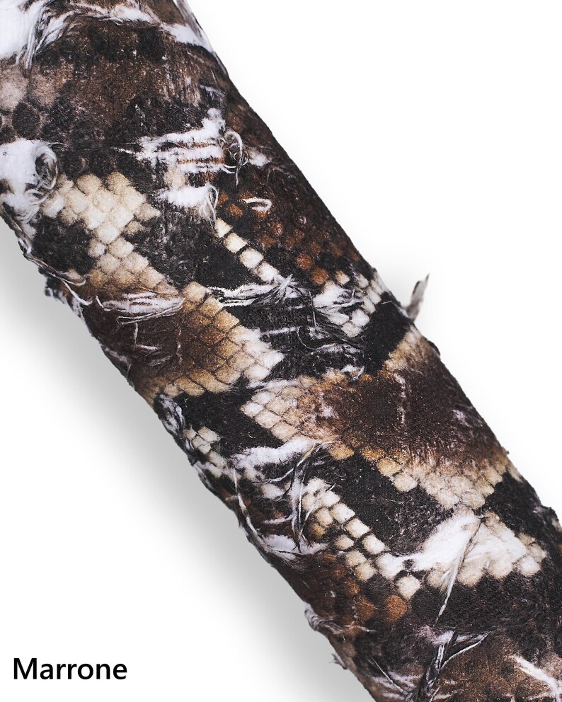 May include: Close-up of a fabric with a snakeskin pattern in shades of brown, beige, and black. The word "Marrone" is printed at the bottom of the image.