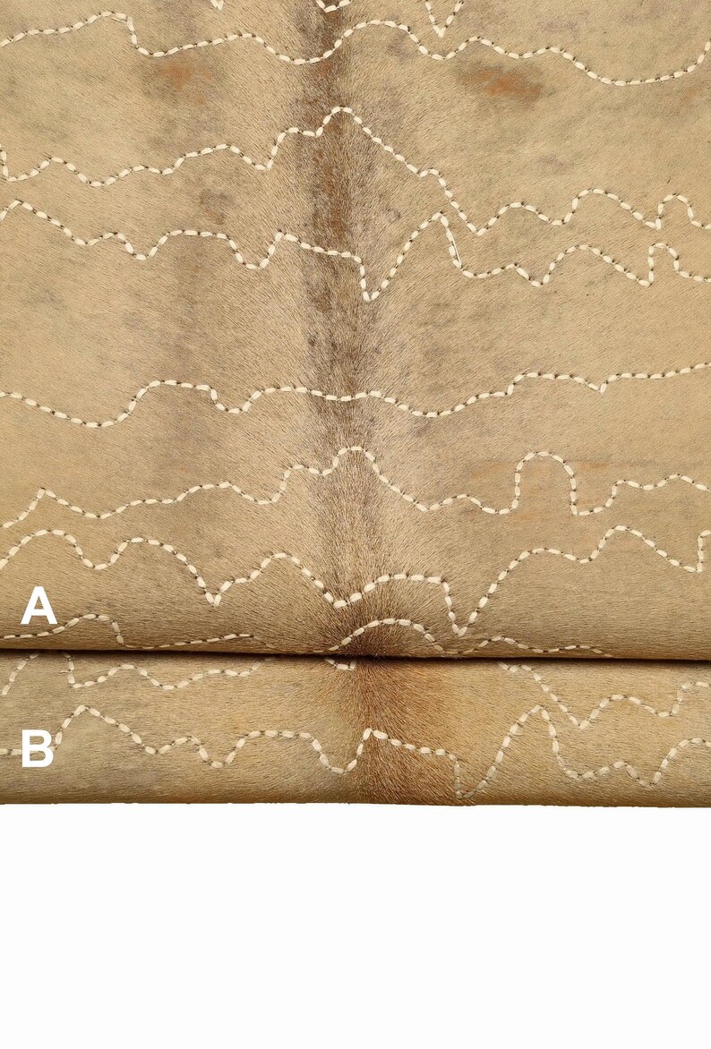 May include: Two pieces of tan cowhide with white stitching in a wavy pattern. The top piece is labeled "A" and the bottom piece is labeled "B".